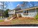 Charming split-level home featuring a garage, a welcoming front yard, and a light-blue painted front door at 5403 Woodberry Cir, Marietta, GA 30068