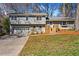 Charming split-level home featuring a garage, a welcoming front yard, and a light-blue painted front door at 5403 Woodberry Cir, Marietta, GA 30068