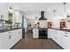 Updated kitchen with white cabinets, stainless steel appliances, black countertops, and a view into the dining area at 5403 Woodberry Cir, Marietta, GA 30068