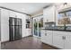 Bright kitchen with white cabinets, stainless steel refrigerator, black countertops, and access to a patio at 5403 Woodberry Cir, Marietta, GA 30068