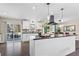 Bright kitchen featuring a large island, white cabinets, black countertops, and stainless steel appliances at 5403 Woodberry Cir, Marietta, GA 30068
