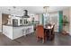 Spacious open-concept layout integrates the kitchen island and the dining area, enhanced by pendant lights at 5403 Woodberry Cir, Marietta, GA 30068