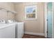 Functional laundry room equipped with a washer, dryer, and shelving at 5403 Woodberry Cir, Marietta, GA 30068