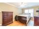 Bedroom featuring a wood frame bed, dresser, ceiling fan, hardwood floors and natural lighting at 885 Briarcliff Ne Rd # D3, Atlanta, GA 30306