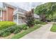 Brick condominium building with balconies and landscaped grounds along a sidewalk at 885 Briarcliff Ne Rd # D3, Atlanta, GA 30306