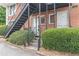 Exterior view of a brick building with an outdoor staircase and lush shrubs at 885 Briarcliff Ne Rd # D3, Atlanta, GA 30306