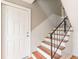 Welcoming foyer with wooden staircase and a stylish black iron railing at 885 Briarcliff Ne Rd # D3, Atlanta, GA 30306
