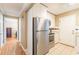 Functional kitchen with stainless steel refrigerator and white cabinetry, open to hallway at 885 Briarcliff Ne Rd # D3, Atlanta, GA 30306