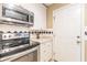 Well-equipped kitchen with stainless steel appliances, white cabinets, and a tiled backsplash at 885 Briarcliff Ne Rd # D3, Atlanta, GA 30306