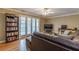 Relaxing living room featuring a large leather sofa, hardwood floors, and a ceiling fan at 885 Briarcliff Ne Rd # D3, Atlanta, GA 30306