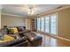 Living room with hardwood floors, ceiling fan, comfortable leather couch and french doors at 885 Briarcliff Ne Rd # D3, Atlanta, GA 30306