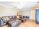 Bright and spacious living room featuring hardwood floors, a leather sectional sofa, and plenty of natural light at 885 Briarcliff Ne Rd # D3, Atlanta, GA 30306