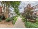 Scenic walkway with lush landscaping, mature trees, and charming lamp posts leading towards building entries and common areas at 885 Briarcliff Ne Rd # D3, Atlanta, GA 30306
