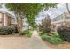 Picturesque walkway lined with mature trees, bushes, and lamp posts, creating a serene and inviting atmosphere at 885 Briarcliff Ne Rd # D3, Atlanta, GA 30306