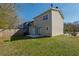 A view of the home's backyard featuring a fenced in yard, a concrete patio and green grass at 2102 Lenoa Ln, Austell, GA 30106