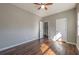 Bedroom featuring hardwood floors, modern ceiling fan and access to hallway at 2102 Lenoa Ln, Austell, GA 30106