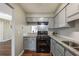 Updated kitchen showcasing granite countertops, gray cabinets, and stainless steel gas range at 2102 Lenoa Ln, Austell, GA 30106