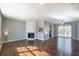 Open-concept living room featuring hardwood floors, a fireplace, ceiling fan and access to a patio at 2102 Lenoa Ln, Austell, GA 30106