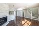 Spacious living room with a fireplace, hardwood floors, and stairs leading to the upper level at 2102 Lenoa Ln, Austell, GA 30106