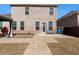 The brick backyard offers a covered patio, ample seating and outdoor grill at 2286 Cadenza Cir, Dacula, GA 30019