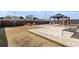 Spacious backyard with a paved patio area, gazebo, lush grass, and a well-maintained privacy fence at 2286 Cadenza Cir, Dacula, GA 30019