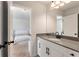 Bathroom boasts gray countertops with black hardware and faucet, with a view of the bedroom at 2286 Cadenza Cir, Dacula, GA 30019