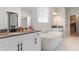 Bright bathroom featuring a freestanding tub, double vanity, and walk-in closet at 2286 Cadenza Cir, Dacula, GA 30019