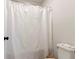 Bright bathroom featuring a white shower curtain and toilet, offering a clean and functional space at 2286 Cadenza Cir, Dacula, GA 30019