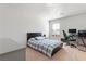 This is a bedroom with light, neutral-colored walls, carpet, a bed with plaid bedding, a desk, and an ergonomic chair at 2286 Cadenza Cir, Dacula, GA 30019