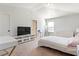 Bedroom features an entertainment center, carpet, and ample lighting at 2286 Cadenza Cir, Dacula, GA 30019