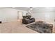 Large bonus room with reclining seating, coffee table and a view to a brightly lit kitchen at 2286 Cadenza Cir, Dacula, GA 30019