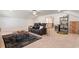 Bonus room featuring a plush seating area, bar, and a view to the stairway at 2286 Cadenza Cir, Dacula, GA 30019
