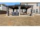 The covered patio features lovely furniture and creates the perfect outdoor living space at 2286 Cadenza Cir, Dacula, GA 30019