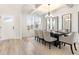 Dining room with coffered ceiling, modern chandelier, a table for eight and three decorative mirrors at 2286 Cadenza Cir, Dacula, GA 30019