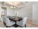 Dining room with coffered ceiling, modern chandelier, a table for six and decorative mirrors at 2286 Cadenza Cir, Dacula, GA 30019