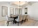 Dining room with coffered ceiling, modern chandelier, a table for eight and three decorative mirrors at 2286 Cadenza Cir, Dacula, GA 30019