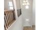 Bright foyer features a modern chandelier, staircase, black railings, and a view of the front entrance at 2286 Cadenza Cir, Dacula, GA 30019