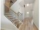 Bright foyer with wood stairs and black iron spindles at 2286 Cadenza Cir, Dacula, GA 30019