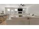 Bright, open-concept living room with modern fireplace and adjacent kitchen and dining area at 2286 Cadenza Cir, Dacula, GA 30019