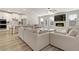 Open living room with white sofa, fireplace, and adjacent kitchen and dining area at 2286 Cadenza Cir, Dacula, GA 30019