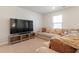 Cozy living area boasting plush carpeting, a comfortable sofa with decorative cushions and a large screen television at 2286 Cadenza Cir, Dacula, GA 30019