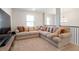 Bright living room featuring neutral colored walls, carpet flooring and a comfortable sectional with decorative pillows at 2286 Cadenza Cir, Dacula, GA 30019