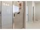 Shower with marble-look tile, a glass enclosure, and a built-in niche at 2286 Cadenza Cir, Dacula, GA 30019