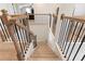 Elegant staircase with stained wood railings, black metal balusters, and beautifully patterned flooring at 2286 Cadenza Cir, Dacula, GA 30019