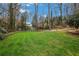 Expansive backyard with lush green lawn, mature trees, and privacy landscaping at 3266 Bruckner Blvd, Snellville, GA 30078