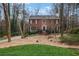 Charming brick home with a landscaped front yard nestled among mature trees at 3266 Bruckner Blvd, Snellville, GA 30078