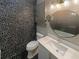 Stylish bathroom featuring unique accent wall, round mirror, and modern vanity at 560 Dutch Valley Ne Rd # 2301, Atlanta, GA 30324