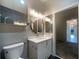 Modern bathroom with gray walls, vanity with round mirror, and sleek fixtures at 560 Dutch Valley Ne Rd # 2301, Atlanta, GA 30324