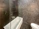 Modern bathroom featuring a unique stone tile shower, soaking tub, and sleek fixtures at 560 Dutch Valley Ne Rd # 2301, Atlanta, GA 30324