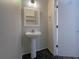 Cozy half bath with pedestal sink and patterned accent floor at 560 Dutch Valley Ne Rd # 2301, Atlanta, GA 30324